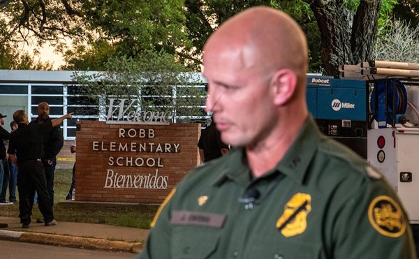 A U.S. Customs and Border Protection agent speaks to a reporter near the scene of a mass shooting at Robb Elementary School on May 24, 2022, in Uvalde.