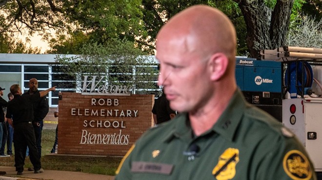 A U.S. Customs and Border Protection agent speaks to a reporter near the scene of a mass shooting at Robb Elementary School on May 24, 2022, in Uvalde.