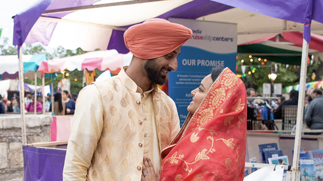 Revelers pause for a romantic moment at 2019's Festival of India.