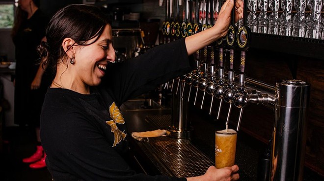 Natalia Montemayor at Longtab Brewing in Leon Valley serves up a beer. The brewery' owner said he’s heard tales of gloom and doom from other beermakers but continues to expand his operation.
