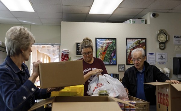 Volunteers from left to right, Evelyn McMillen, Leigh Cox and Victor Surita help to package orders of groceries at El Buen Samaritano food pantry in Austin on Nov. 14.