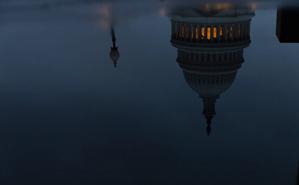 The U.S. Capitol, seen in a reflection, on a cloudy evening Jan. 22, 2023 in Washington D.C