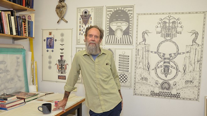 Artist James Smolleck in his home studio with recent works including the 2021 drawing The Goblin Scapegoat.