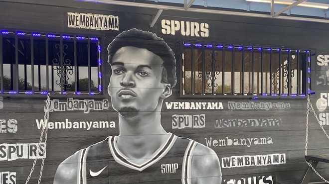 Spurs fans lined up to take photos at this mural of French phenom Victor Wembanyama wearing a Spurs jersey.