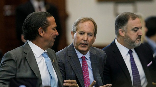 Texas Attorney General Ken Paxton, center, talks with his defense attorney Tony Buzbee, left, before starting the ninth day of his impeachment trial in the Senate Chamber at the Texas Capitol on Friday, Sept. 15, 2023.