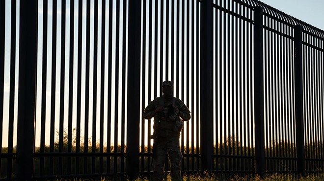 A National Guard soldier oversees an area where the border wall ends in Del Rio, on Nov. 7, 2021.