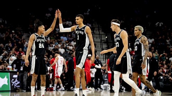 Spurs rookie Victor Wembanyama high-fives teammate Devin Vassell during a matchup against the Houston Rockets earlier this season.