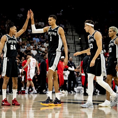 Spurs rookie Victor Wembanyama high-fives teammate Devin Vassell during a matchup against the Houston Rockets earlier this season.