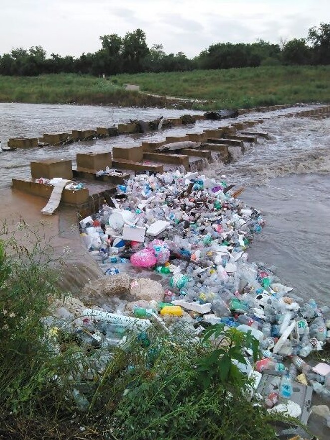 Trash from Fiesta clogs the San Antonio River. - SAN ANTONIO RIVER AUTHORITY