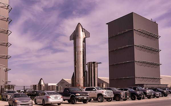 A rocket towers above SpaceX's South Texas facility.