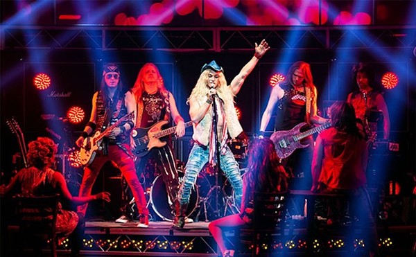 An earlier cast of Rock of Ages struts its stuff onstage.