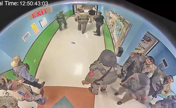 Police officers wait in the halls of Robb Elementary School during the state's deadliest campus shooting.