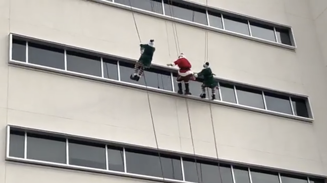 Santa Claus and two elves rappelled down the hospital building to greet children through the windows.