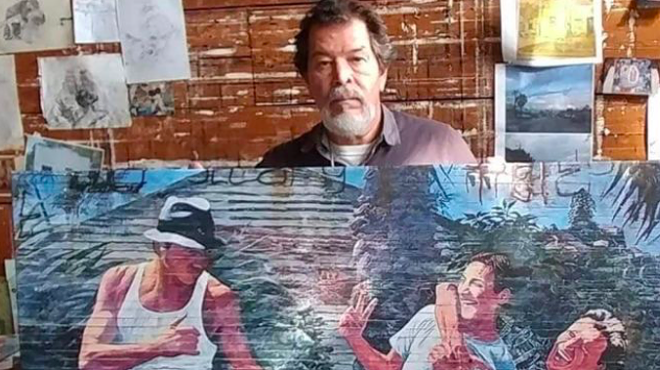 Adan Hernanez holds up one of his paintings in a photo shared on a GoFundMe account set up to cover his funeral expanses.