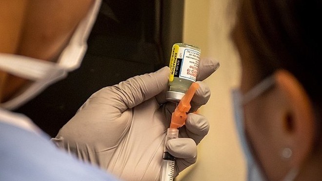 Hospital personnel prepare to administer a dose of Moderna's COVID-19 vaccine.