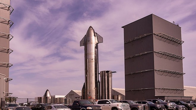A rocket towers above SpaceX's South Texas facility.