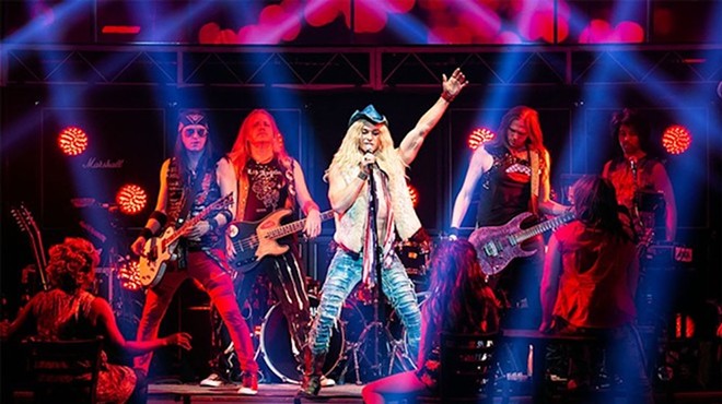An earlier cast of Rock of Ages struts its stuff onstage.