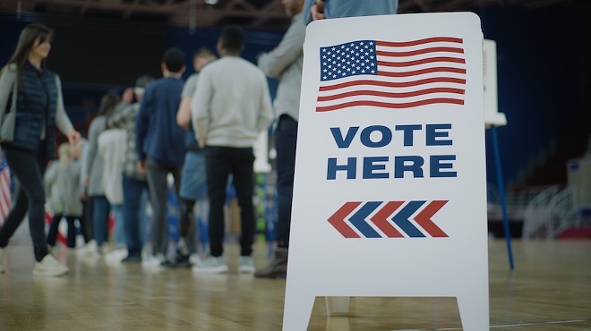 Voters line up to cast ballots at a polling location.