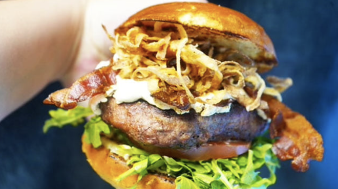 The G.O.A.T. burger features roasted goat cheese, smoky bacon and fried onion strings.