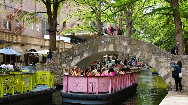 Tourists take a barge along the San Antonio River.