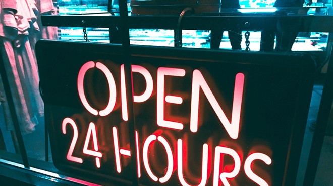 A neon "open 24 hours" sign.
