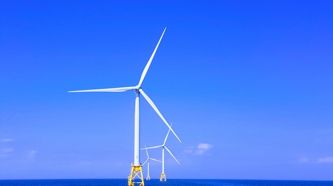 Offshore wind turbines provide power.