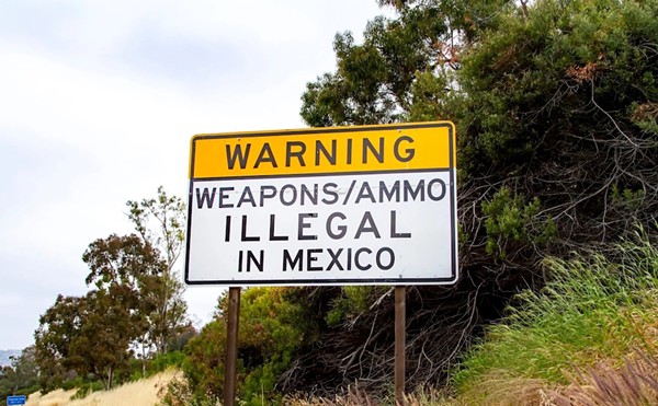 A sign near the U.S. border in San Diego warns that it's illegal to bring in guns from the United States.