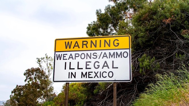 A sign near the U.S. border in San Diego warns that it's illegal to bring in guns from the United States.