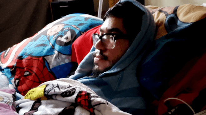 Ralph Garcia, a San Antonio man with muscular dystrophy, and his mother have closed themselves off in his bedroom and packed the window with sblankets to stay warm.