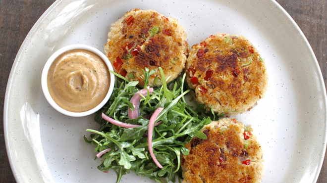 Rivulet's crab cakes are served with arugula salad, a side and remoulade.