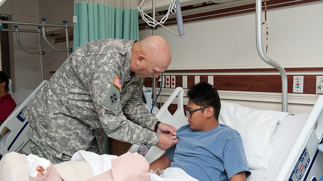 U.S. Army Chief of Staff Gen. Raymond T. Odierno pins a Purple Heart Medal on a wounded soldier at Brooke Army Medical Center in this 2011 image.