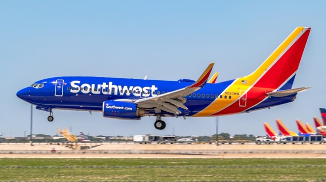 A Southwest Airlines 737-700 lands at an airport.