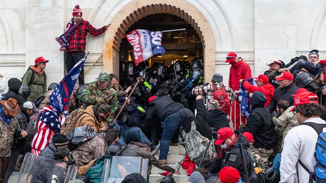 Police battle with supporters of Donald Trump as they try to enter the front doors of the U.S. Capitol on January 6.