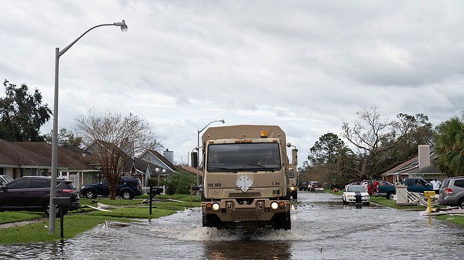 Louisiana National Guard members in high-water vehicles and boats work with St. John the Baptist Parish officials to rescue citizens stranded in their homes in the wake of Hurricane Ida.
