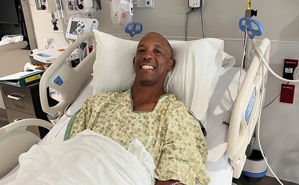 Sean Elliott smiles from his hospital bed after being treated by Methodist Healthcare in San Antonio.