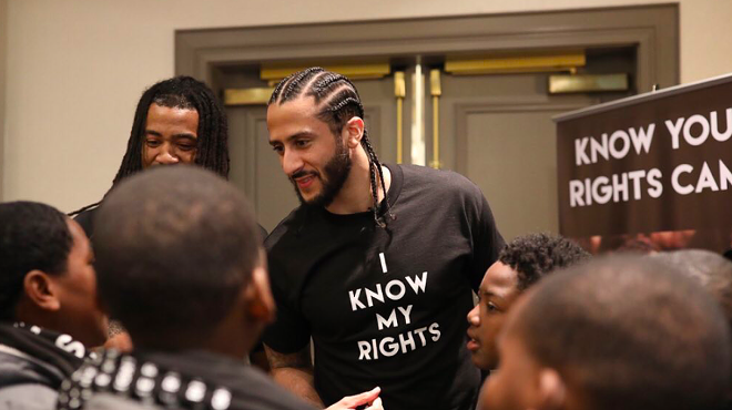 Colin Kaepernick meets with young people at one of his Know Your Rights camps.