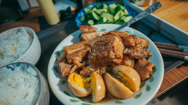 Pork adobo with hard-boiled eggs and rice is a popular dish in the Philippines.
