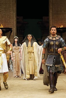 Seti (John Turturro, background) presents the future leaders of Egypt: Ramses (Joel Edgerton, left) and Moses (Christian Bale)