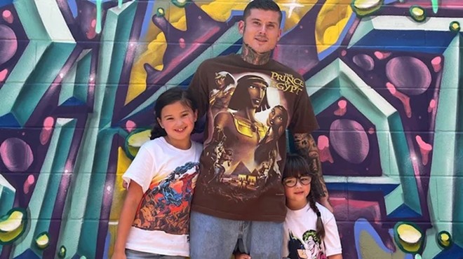 Smack's Chicken Shack owner Keenen Hendricks poses with his two children.