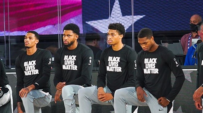 Members of the San Antonio Spurs take a knee during a recent game.