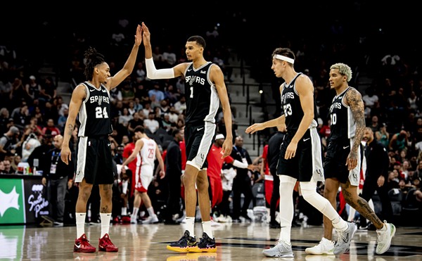 Spurs forward Victor Wembanyama high-fives teammate Devin Vassell during a matchup against the Houston Rockets earlier this season.