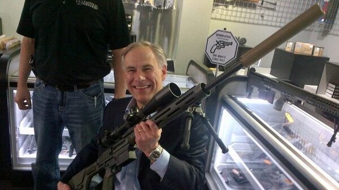 Gov. Get Abbott poses with a weapon during a gun-store photo op.