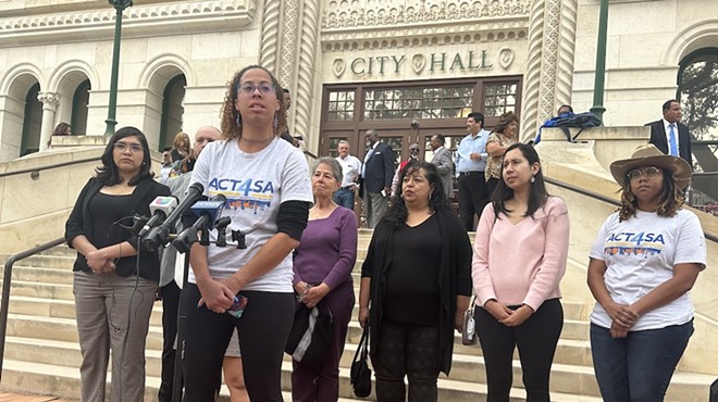 Ananda Tomas, executive director of police reform advocacy group Act 4 SA, accuses city attorney Andy Segovia of "undermining democracy" during a press conference at City Hall on Monday.