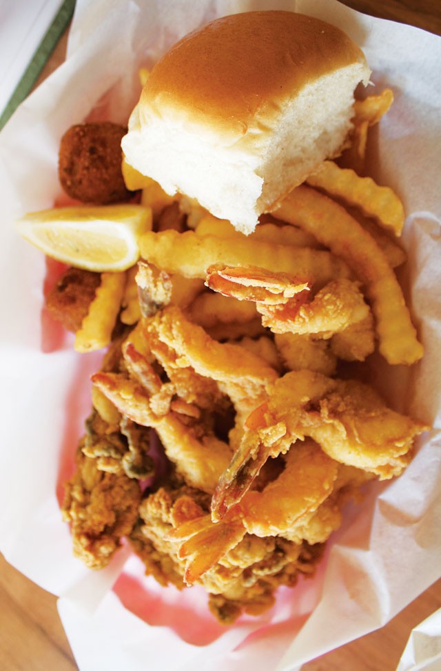 Surf and surf: Fried shrimp and fried oysters served with fries, hush puppies, and bread from Fishland. - VERONICA LUNA