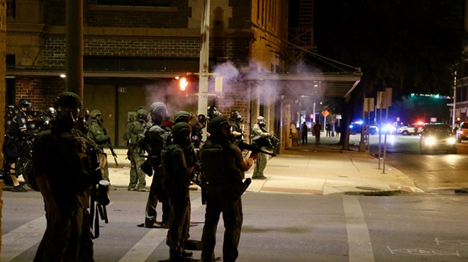 San Antonio police patrol downtown after using tear gas to clear demonstrators.