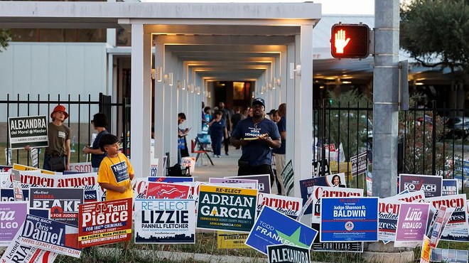 Signs and electioneers greet voters at the Metropolitan Multi-Service Center in Houston, Tuesday Nov. 8, 2022.