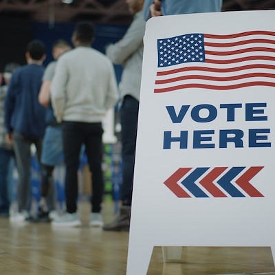 Voters line up to cast ballots at a polling location.