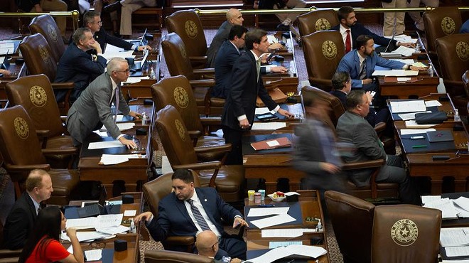 Members of the House move to vote at their desks on the House floor at the state Capitol on May 28, 2021.