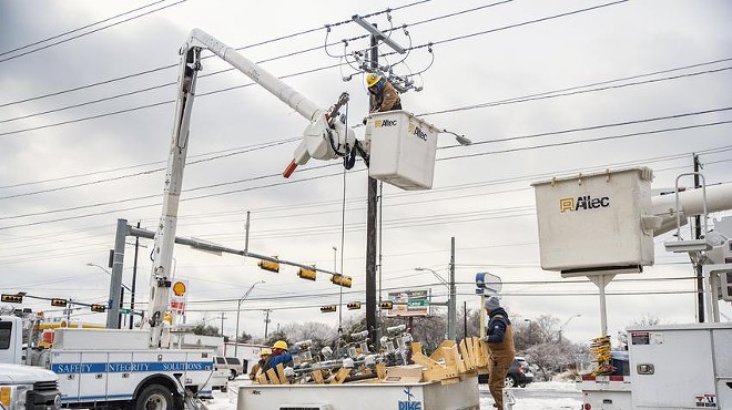 Electrical workers repair a power line in Austin on Feb. 18, 2021, during the winter storm that nearly collapsed the state’s power grid. The state grid operator’s seasonal forecast says extreme weather this winter could lead to calls to reduce power use — or even rolling blackouts.