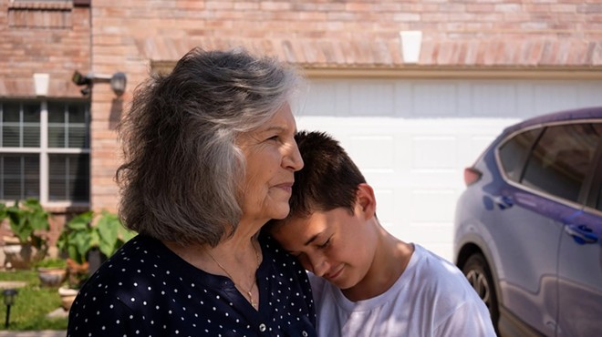 Mercedes Bristol, 68, executive director of Texas Grandparents Raising Grandchildren, left, and her youngest grandson, Paul Chavez, 12, hold each other in their front yard in San Antonio on June 16, 2023. Bristol is the primary caretaker of her five grandchildren, including Paul, who is the youngest. “We’re called the invisible foster care, the hidden foster care, nobody knows about this group of people that are raising grandchildren,” Bristol said.